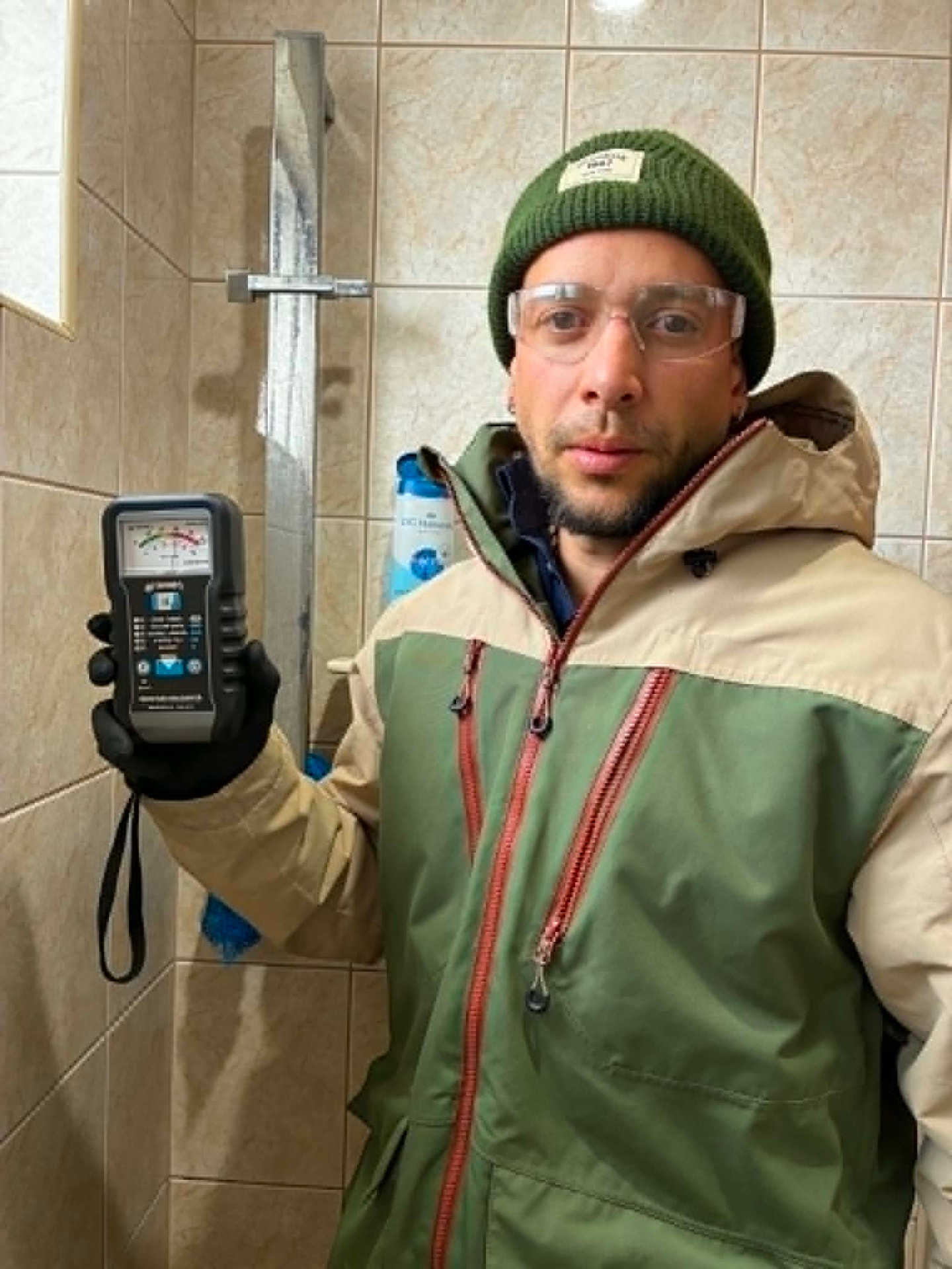 Fabien holding a moisture meter during an inspection